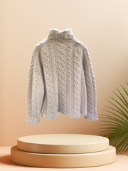 Seventy Sweater in soft gray cashmere, featuring a turtle neck and cable knit design, showcased on a minimal pedestal.